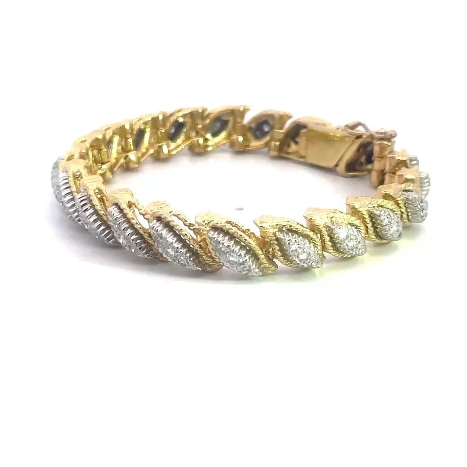 DIAMOND GOLD BRACELET 1.45CT 18K TWO TONE DOUBLE LEAF LINK STYLE 49.5GR: DIAMOND GOLD BRACELET 1.45CT 18K TWO TONE DOUBLE LEAF LINK STYLE 49.5GR This gorgeous diamond bracelet features a stunning design with 2 layered chasing leaf-shaped links, crafted from 18k yellow and 