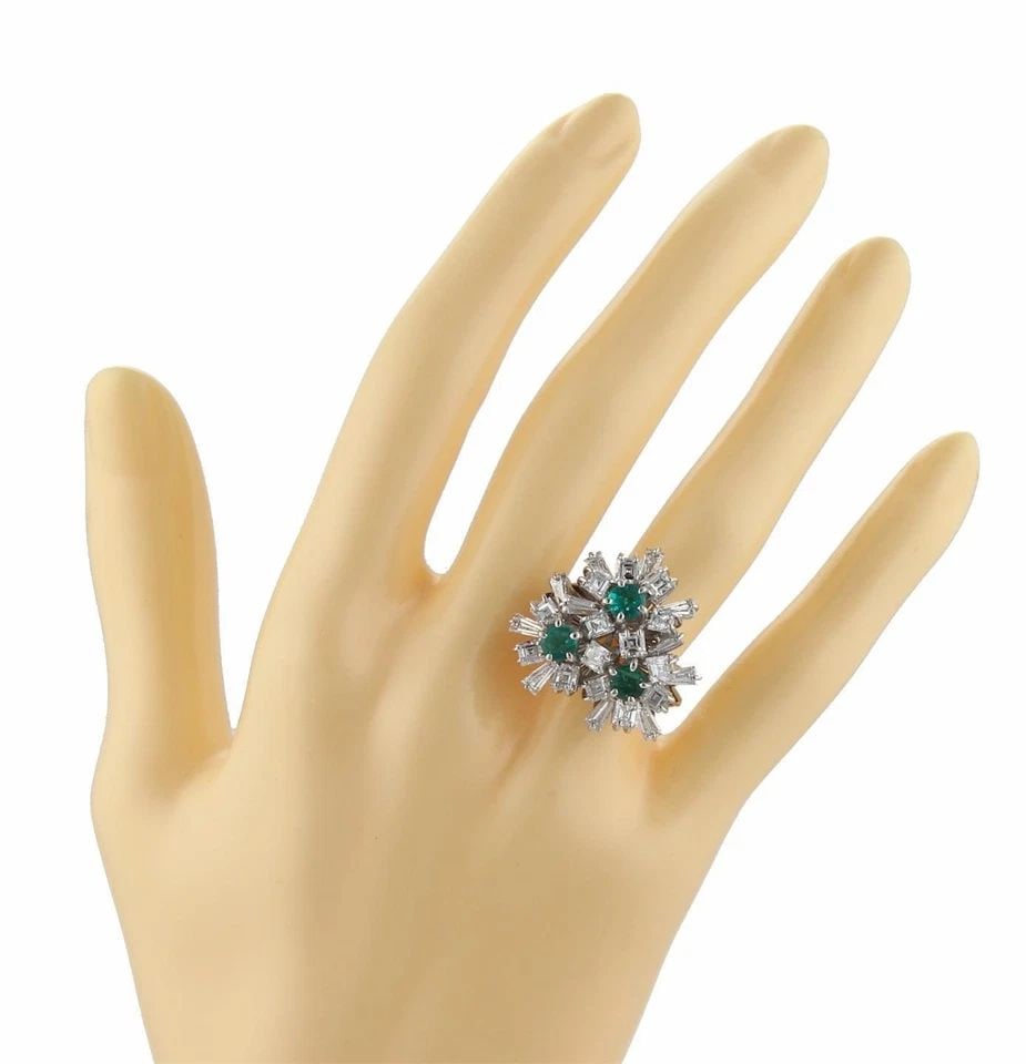 DIAMOND & EMERALD 18K WHITE GOLD ESTATE TRIPLE FLORAL RING: DIAMOND & EMERALD 18K WHITE GOLD ESTATE TRIPLE FLORAL RING Estate Diamond & Emerald 14k White Gold Triple Floral Ring Description This is a stunning white gold, diamonds and emeralds floral cocktail r
