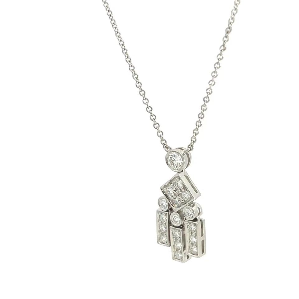 TIFFANY & CO. LEGACY NECKLACE DIAMOND PLATINUM MOVABLE FIGURE: TIFFANY & CO. LEGACY NECKLACE DIAMOND PLATINUM MOVABLE FIGURE This lovely pendant and chain necklace is by Tiffany & Co. from the Legacy Collection. It is crafted from platinum. The pendant features a