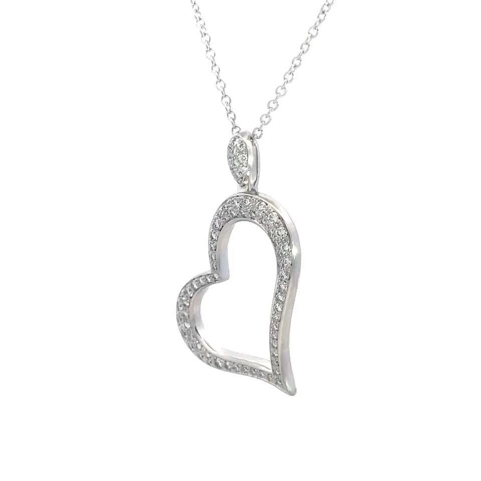 PIAGET DIAMOND GOLD HEART NECKLACE 18K WHITE PAVE SET W/CHAIN: PIAGET DIAMOND GOLD HEART NECKLACE 18K WHITE PAVE SET W/CHAIN This charming authentic pendant and chain is by Piaget, they are crafted from 18k white gold with a polished finish. The pendant features 