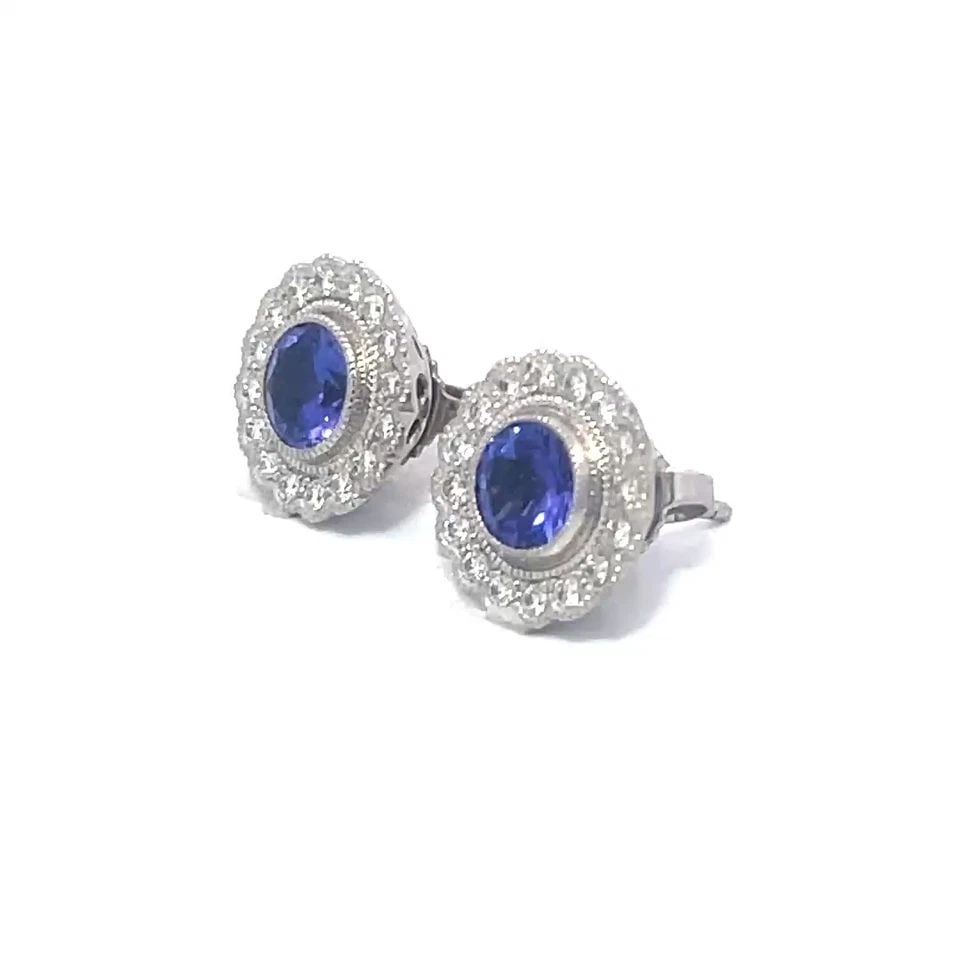 TIFFANY & CO. SOLESTE TANZANITE EARRINGS PLATINUM DIAMOND STUD HALO STYLE: TIFFANY & CO. SOLESTE TANZANITE EARRINGS PLATINUM DIAMOND STUD HALO STYLE These gorgeous earrings belong to the Tiffany Soleste Collection. They are platinum and is inspired by the warmth and energy o