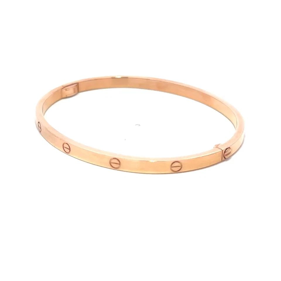CARTIER LOVE GOLD BANGLE SMALL MODEL 18K ROSE SIZE 17 BOX & PAPER: CARTIER LOVE GOLD BANGLE SMALL MODEL 18K ROSE SIZE 17 BOX & PAPER This elegant bangle is by Cartier, from 18k rose gold, it features a screw closure and signed by the brand. This small model bangle, s