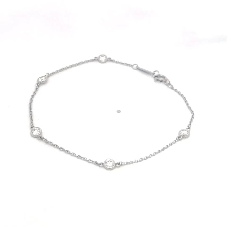 TIFFANY & CO. DIAMOND BY THE YARD BRACELET PERETTI PLATINUM 5 BEZEL PAPER: TIFFANY & CO. DIAMOND BY THE YARD BRACELET PERETTI PLATINUM 5 BEZEL PAPER The Tiffany & Co. Diamond by the Yard Bracelet in platinum features 5 round natural white diamonds set in a bezel style. It ha