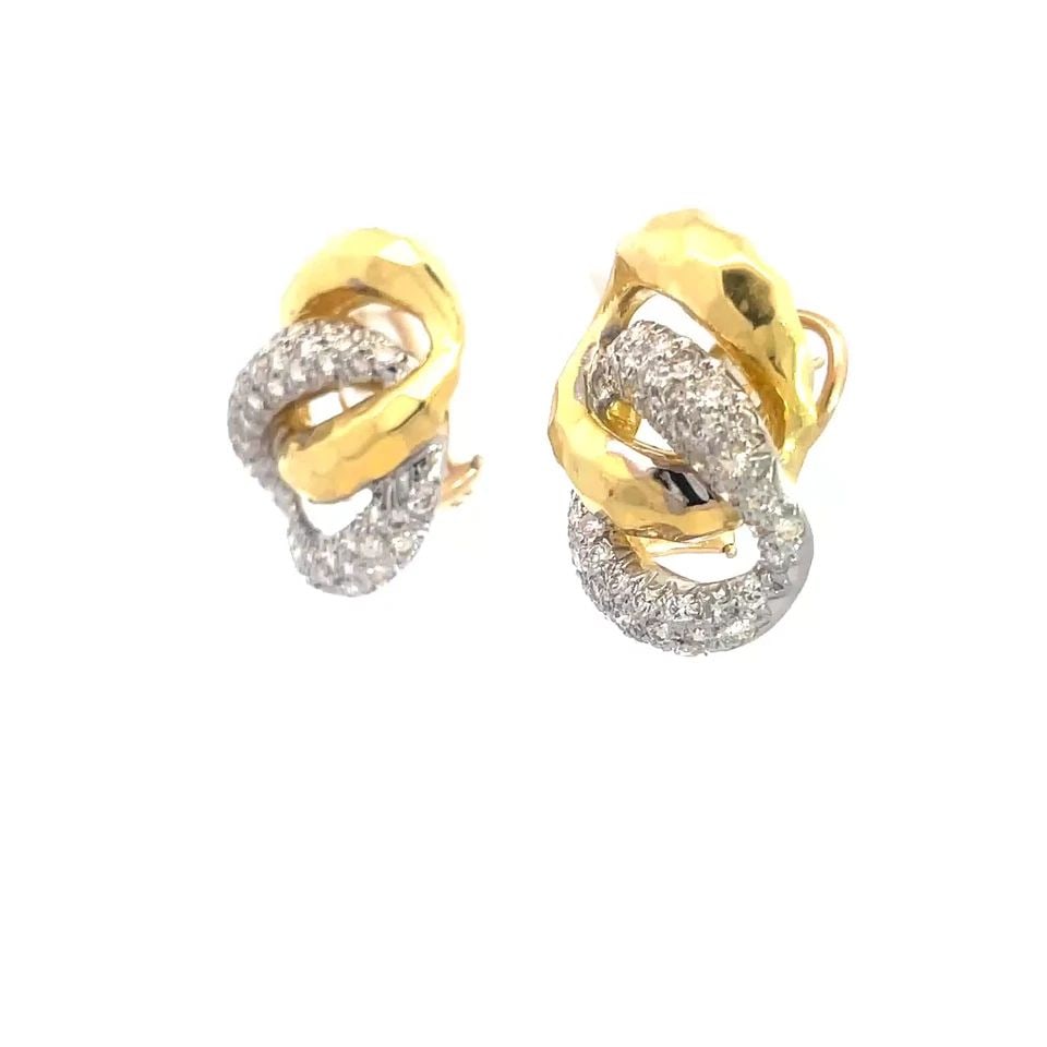 DIAMOND GOLD EARRINGS 18K TWO TONE HAMMERED PAVE SET 14K BACKS: DIAMOND GOLD EARRINGS 18K TWO TONE HAMMERED PAVE SET 14K BACKS These 18k two tone gold earrings feature a double circle design adorned with pave set diamonds on the white gold and hammered style on th