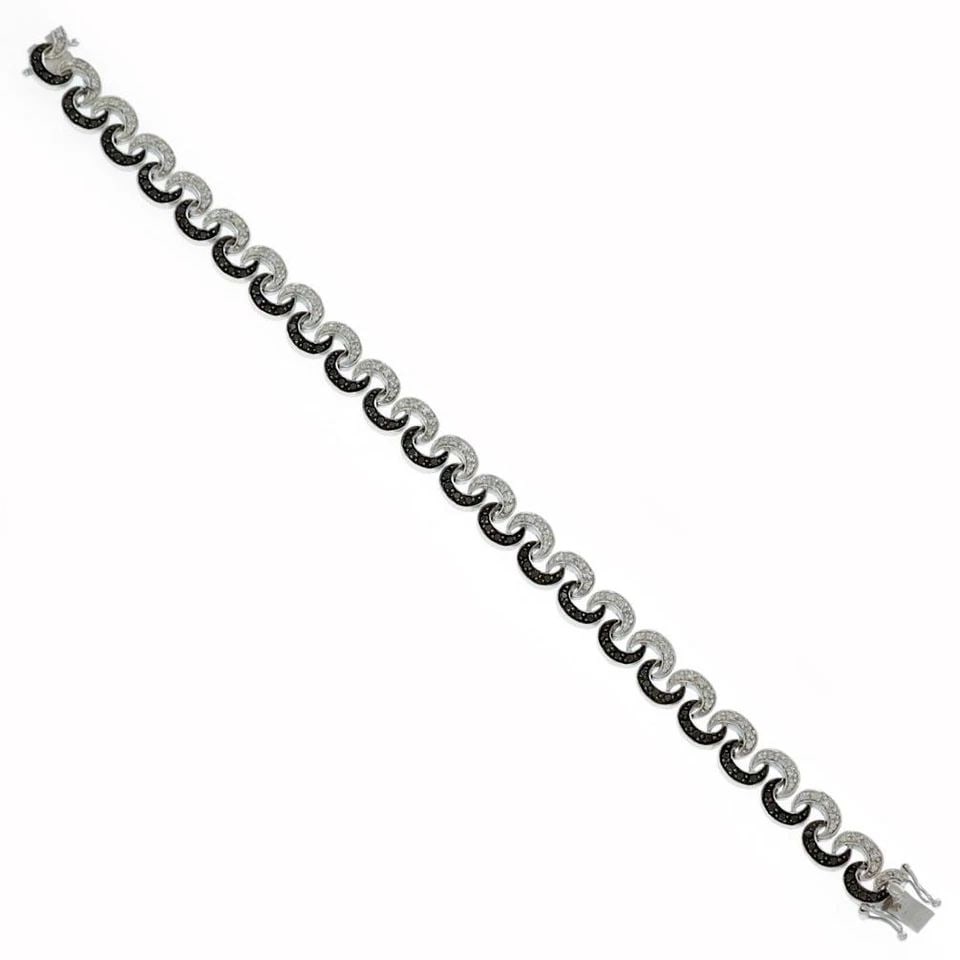 DIAMOND BRACELET 14K WHITE GOLD BLACK & WHITE DIAMONDS: DIAMOND BRACELET 14K WHITE GOLD BLACK & WHITE DIAMONDS This 14k white gold diamond bracelet features a fancy link style with black and white diamonds set in the design. The bracelet has a slide closur