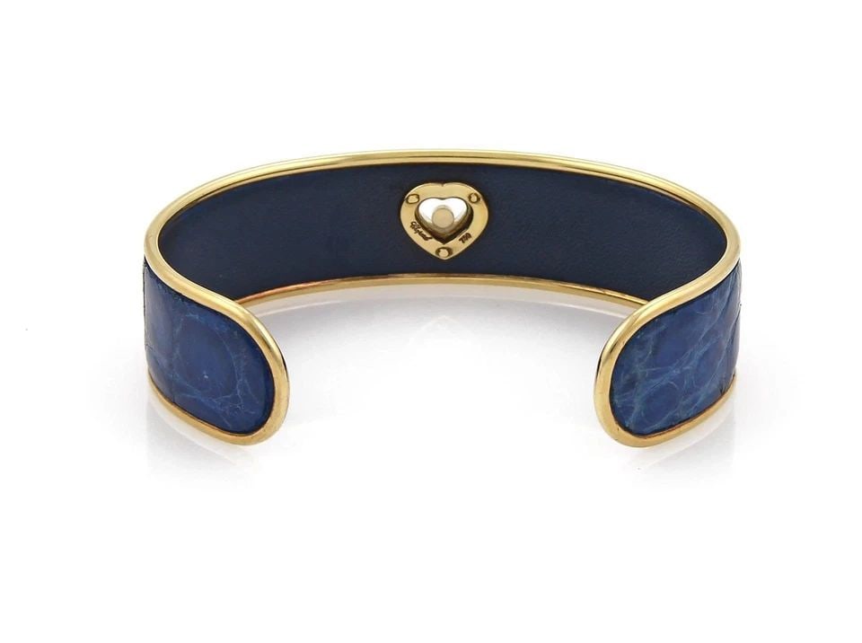 CHOPARD HAPPY DIAMOND BRACELET 18K GOLD HEART BLUE LEATHER CUFF: CHOPARD HAPPY DIAMOND BRACELET 18K GOLD HEART BLUE LEATHER CUFF Chopard Happy Diamond 18k Gold Heart Blue Leather Cuff Bracelet Description This chic authentic cuff bracelet is by Chopard from the Hap