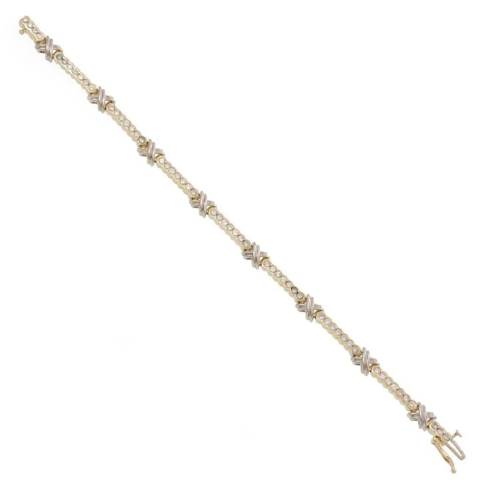 3CT BEZEL DIAMOND 14K TWO TONE GOLD X LING BRACELET: 3CT BEZEL DIAMOND 14K TWO TONE GOLD X LING BRACELET Vintage 3ct Bezel Diamond 14k Two Tone Gold X Ling Bracelet Description This braclet is crafted from 14k yellow and white gold featuring a single ro