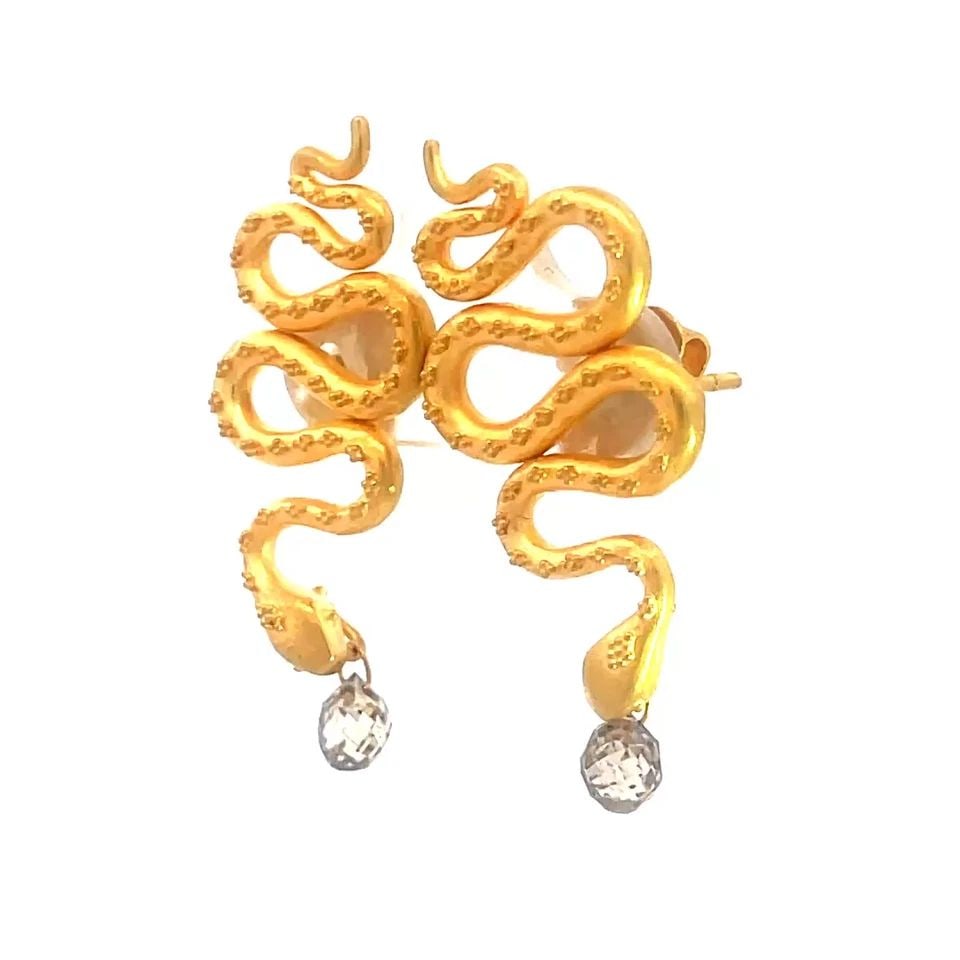 DIAMOND GOLD SNAKE EARRINGS 18K YELLOW BEAD DESIGN BRIOLETTE CUT: DIAMOND GOLD SNAKE EARRINGS 18K YELLOW BEAD DESIGN BRIOLETTE CUT This charming pair of earrings are crafted from 18k yellow gold featuring a full-length snake design with fine bead work with its head 