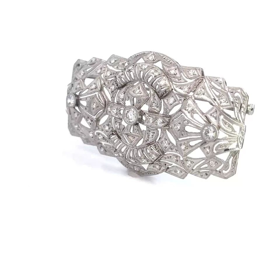 ART DECO DIAMOND PLATINUM BROOCH LARGE OPEN FILIGREE DESIGN: This is a magnificent Art Deco brooch. It is crafted from platinum featuring a wide rectangle shape with larger filigree design with 3 larger round cut bezel set diamonds and smaller round diamonds sc