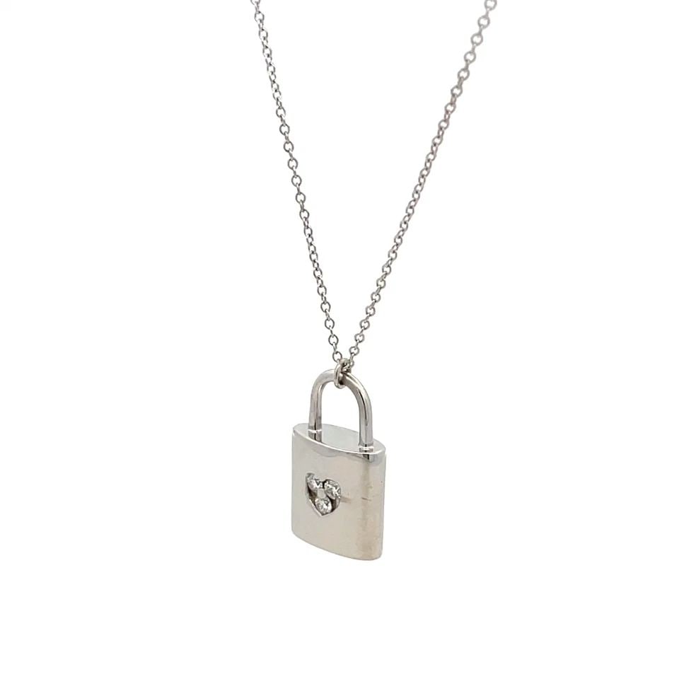 TIFFANY & CO. DIAMOND 18K WHITE GOLD PADLOCK PENDANT & CHAIN NECKLACE: TIFFANY & CO. DIAMOND 18K WHITE GOLD PADLOCK PENDANT & CHAIN NECKLACE This lovely authentic necklace is from Tiffany & Co. from 18k white gold with a high polished finish, the pendant features a class