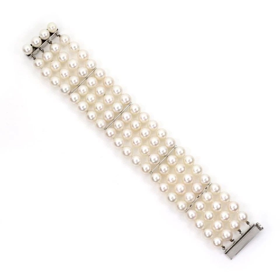 14K WHITE GOLD - 4 STRAND PEARLS WIDE BRACELET: 14K WHITE GOLD - 4 STRAND PEARLS WIDE BRACELET 4 Strand Pearls 14k White Gold Wide Bracelet Description This lovely vintage bracelet is crafted from 14k white gold featuring 4 strands of lustrous pear