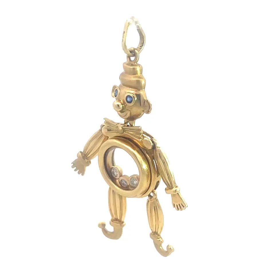 DIAMOND GOLD CLOWN PENDANT 18K YELLOW FULL FIGURE MOVABLE STYLE: This gold clown pendant is a unique and eye-catching piece of jewelry, featuring a full figure clown shape with a movable style. Crafted in 18k yellow gold, the pendant showcases 3 bezel set white dia