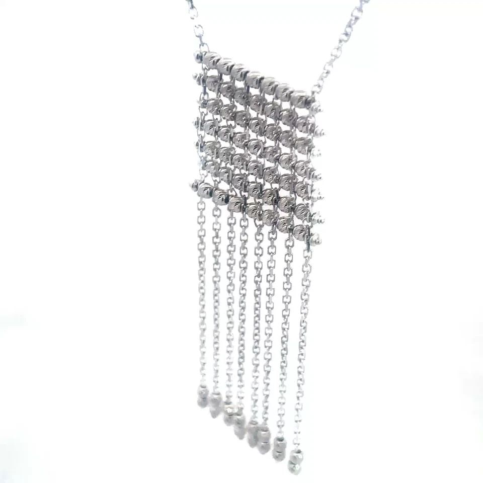 WHITE GOLD 18K FRINGE NECKLACE DIAMOND CUT BEAD TASSEL STYLE W/CHAIN: WHITE GOLD 18K FRINGE NECKLACE DIAMOND CUT BEAD TASSEL STYLE W/CHAIN This eye-catching contemporary necklace features a unique square shape style with diamond cut beads strung on long pins, dangling b