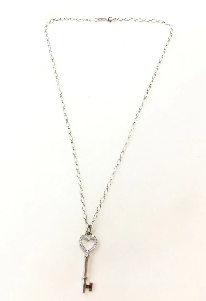 TIFFANY & CO. 18K WHITE GOLD NECKLACE, 0.08CTS DIAMOND HEART KEY CHARM 20" 7.4G: 18K WHITE GOLD TIFFANY & CO.HEART KEY PENDANT/NECKLACE WITH DIAMONDS 18k White Gold Tiffany & Co.Heart Key Pendant/Necklace with Diamonds You are bidding on a 18k White Gold Tiffany & Co.Heart Key Pen