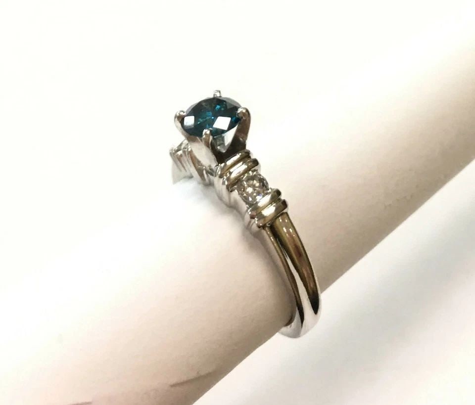 PLATINUM RING, 0.65CT BLUE DIAMOND, 0.83CTW DIAMONDS ( SIZE: 5.5 ) 6.6G: WOMAN'S PLATINUM RING WITH DIAMONDS AND BLUE CENTER DIAMOND (SIZE:5.5) Woman's Platinum Ring with Diamonds and Blue Center Diamond You are bidding on a pre-owned Woman's Platinum Ring with Diamonds an