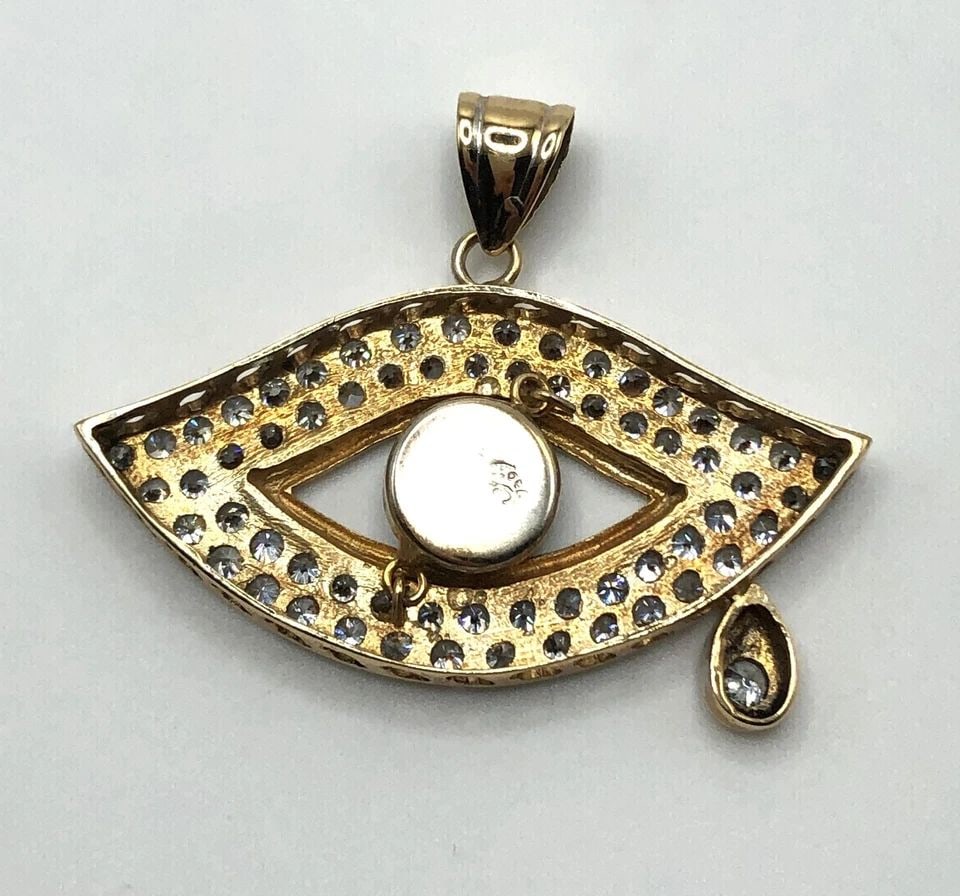 18K YELLOW GOLD EVIL EYE PENDANT WITH CUBIC ZIRCONIA ( 10.7 GRAMS ): 18K GOLD EVIL EYE PENDANT WITH CUBIC ZIRCONIA 10.7G 18k Gold Evil Eye Pendant with Cubic Zirconia 10.7g You are bidding on a 18k Gold Evil Eye Pendant with Cubic Zirconia. The piece has been fully che