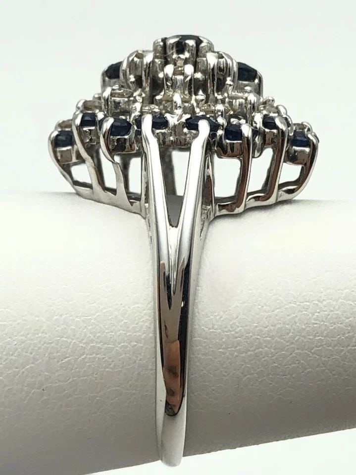 14K WHITE GOLD OVAL CLUSTER RING WITH NATURAL SAPPHIRES AND 0.66CTS OF DIAMONDS: 14K WHITE GOLD OVAL DOME RING WITH NAT SAPPHIRES AND 0.66CTS OF DIAMONDS SIZE 8 14k White Gold oval dome Ring set with Sapphires and 0.66cts of Diamonds Condition: Used, has been moved around in inven