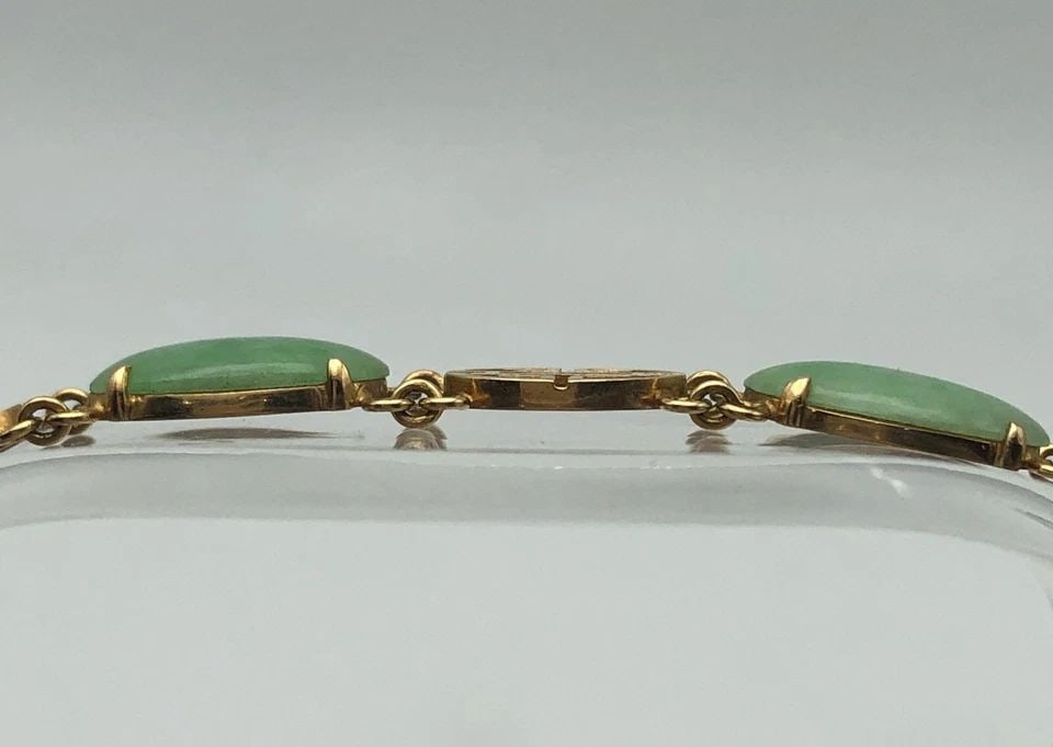 14K GOLD BRACELET WITH SIX OVAL JADE STONES ( 7 INCH ) 11 GRAMS: 14K GOLD BRACELET WITH SIX OVAL JADE STONES 7 INCHES , 11 GRAMS 14k Gold Bracelet with six Oval shaped Jade Stones Condition: Used Material: 14k Yellow Gold Weight: 11.0 grams Bracelet Size: 7 inches 