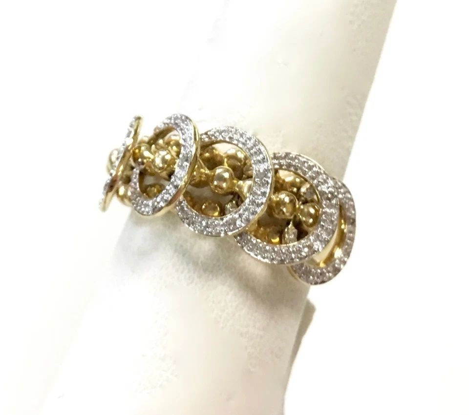 NEW 14K GOLD RING WITH DANGLING HOOPS AND 0.07CTW DIAMONDS (SIZE 7.5) 7.1G: 14K YELLOW GOLD RING WITH DIAMONDS SIZE: 7.5 14k Yellow Gold Ring with Diamonds You are bidding on a 14k Yellow Gold Ring with Diamonds. There are a few minor scratches on the ring from being moved ar