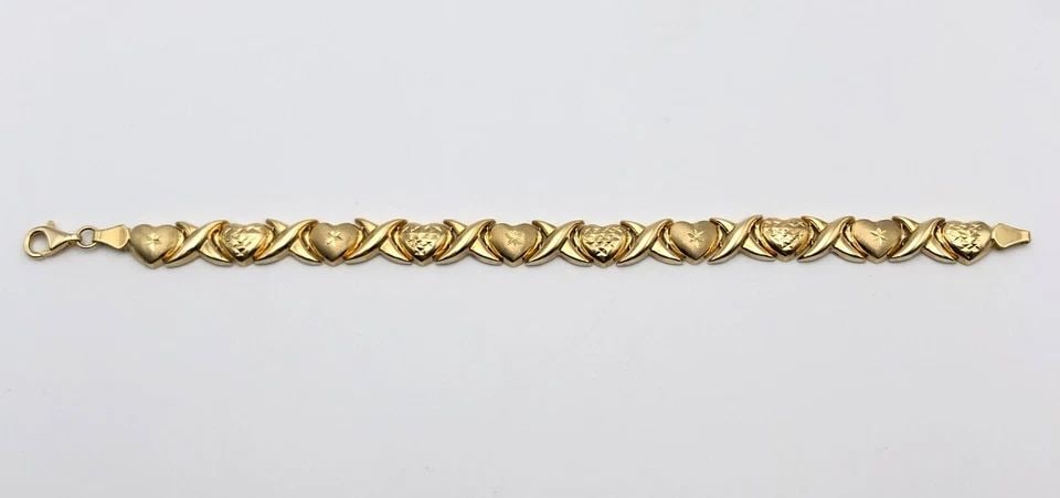 10K GOLD HEART AND CROSS X LINKED BRACELET ( 7.5 INCH ) 7.2G: 10k Gold Heart and Cross X linked Bracelet Condition: Display copy, moved around in inventory, light wear Material: 10k Yellow Gold Weight: 7.2 grams Bracelet Size: 7.5 inches long, 9mm wide Bracelet 