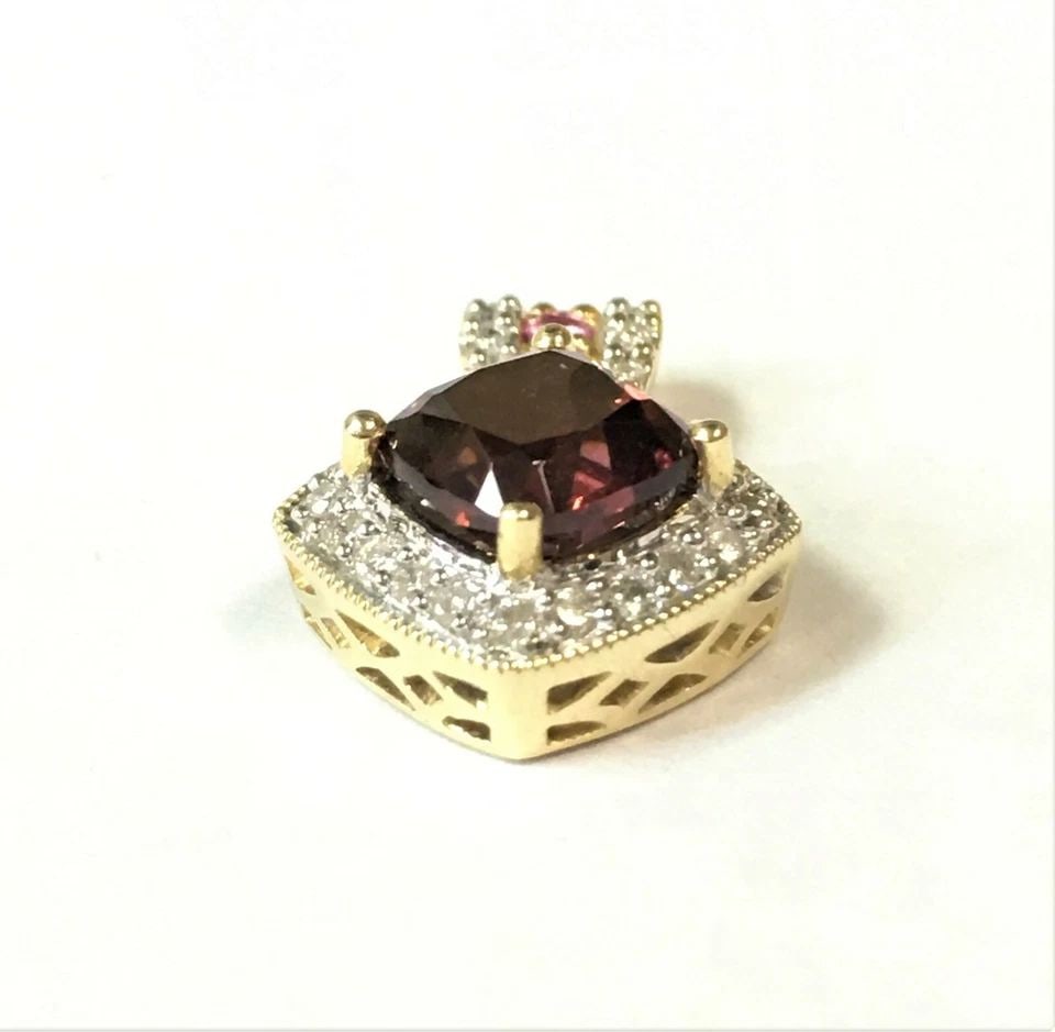 14K GOLD PENDANT WITH GARNET, PINK SAPPHIRES AND 0.33CTS OF DIAMONDS 3.6 GRAMS: 14k Gold Pendant with Garnet, Pink Sapphires and 0.33cts of Diamonds You are bidding on a 14k Yellow Gold Pendant with Center Garnet, Pink Sapphire and Diamonds. The piece has been fully checked and i