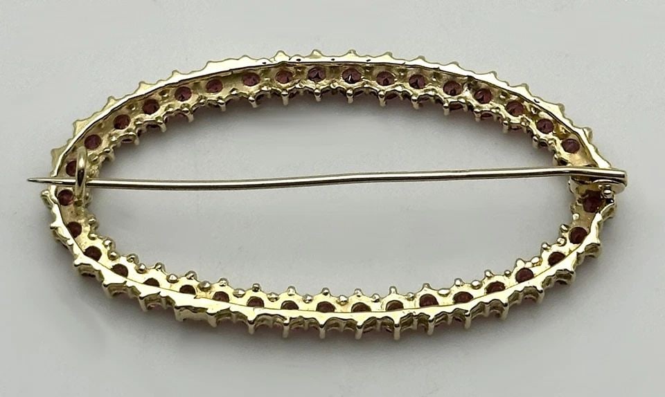 14K GOLD OVAL SHAPED BROOCH SET WITH 0.55CTS OF PINK TOURMALINE 4.2 GRAMS: 14K GOLD OVAL SHAPED BROOCH SET WITH 0.55CTS OF PINK TOURMALINE 4.2 GRAMS 14k Gold Oval Shaped Brooch set with 0.55cts of Pink Tourmaline Condition: Used, has been cleaned Material: 14k Yellow Gold Br