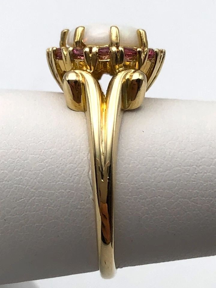 14K YELLOW GOLD RING SET WITH 1CT OPAL AND PINK CUBIC ZIRCONIA (SIZE 7.5) 4.4G: 14K YELLOW GOLD RING SET WITH OPAL AND PINK CUBIC ZIRCONIA SIZE: 7.5 14k Yellow Gold Ring set with Opal and Pink Cubic Zirconia Condition: Used, has been moved around in inventory Material: 14k Yellow