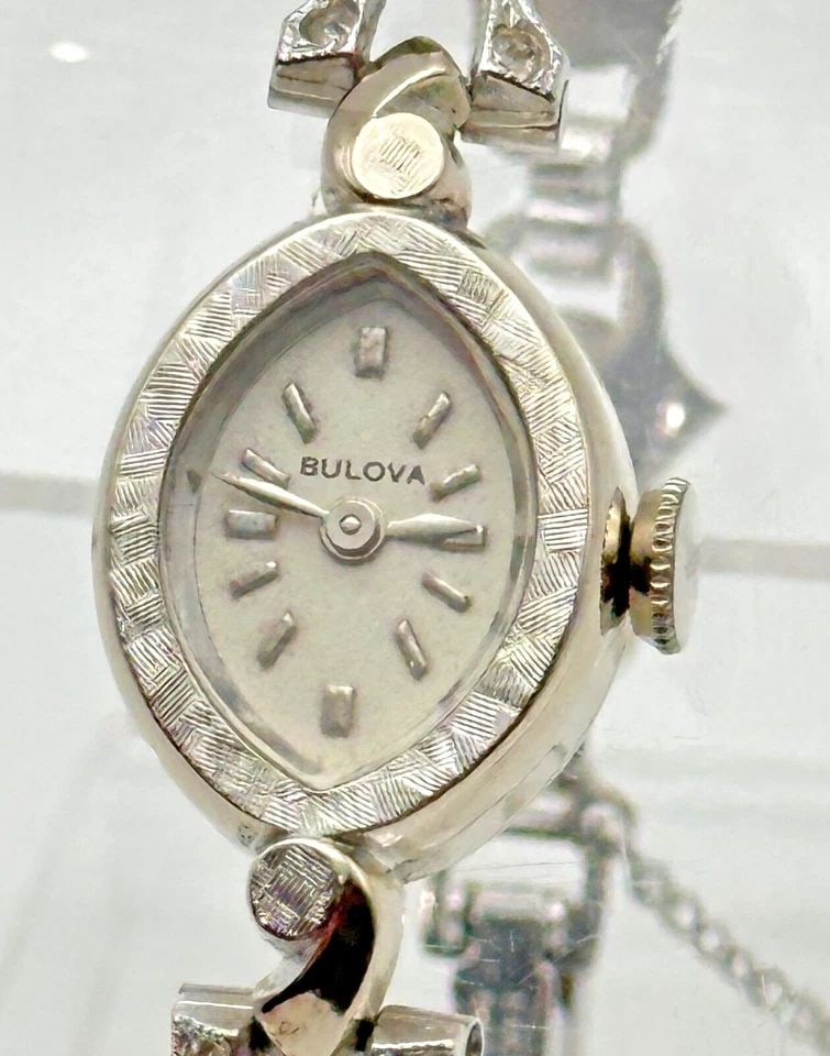 VINTAGE BULOVA WATCH 14K WHITE GOLD CASE AND STERLING BAND WITH CUBIC ZIRCONIA: VINTAGE BULOVA WATCH 14K WHITE GOLD CASE AND STERLING BAND WITH CUBIC ZIRCONIA Vintage Bulova Watch 14k White Gold Case and Sterling Band with Cubic Zirconia Condition: Used / Vintage, runs and keeps 