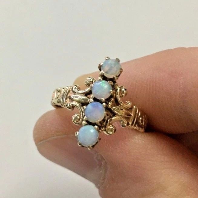 VINTAGE 14K GOLD RING WITH FOUR NATURAL OPALS (SIZE 6) 3.2 GRAMS: 14K GOLD RING WITH OPAL STONES SIZE: 6 14k Gold Ring with Opal stones You are bidding on a 14k Gold Ring with genuine Opal stones. There maybe a few minor scratches on the ring from being moved around