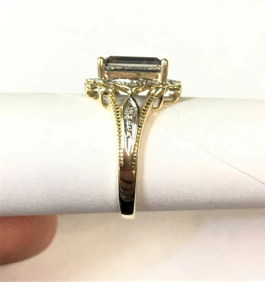 10K GOLD RING WITH CENTER MYSTIC TOPAZ, 0.06CTW DIAMONDS (SIZE 7.25) 3.2 GRAM: 10K YELLOW GOLD WITH CENTER MYSTIC TOPAZ AND DIAMONDS (SIZE: 7.25) 10k Yellow Gold with center Mystic Topaz and Diamonds You are bidding on a 10k Yellow Gold with center Mystic Topaz and Diamonds. The