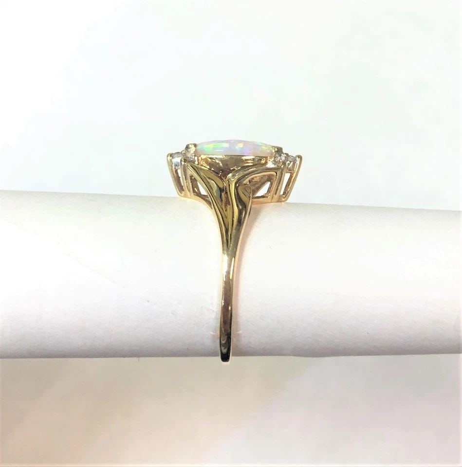 10K GOLD RING, MARQUISE NATURAL OPAL, 0.16CTW DIAMONDS (SIZE 6.5) 2.3 GRAM: 10K GOLD RING WITH MARQUISE NATURAL OPAL AND DIAMONDS (SIZE: 6.5) 10k Gold Ring with marquise Natural Opal and Diamonds You are bidding on a 10k Gold Ring with marquise Natural Opal and Diamonds. The 