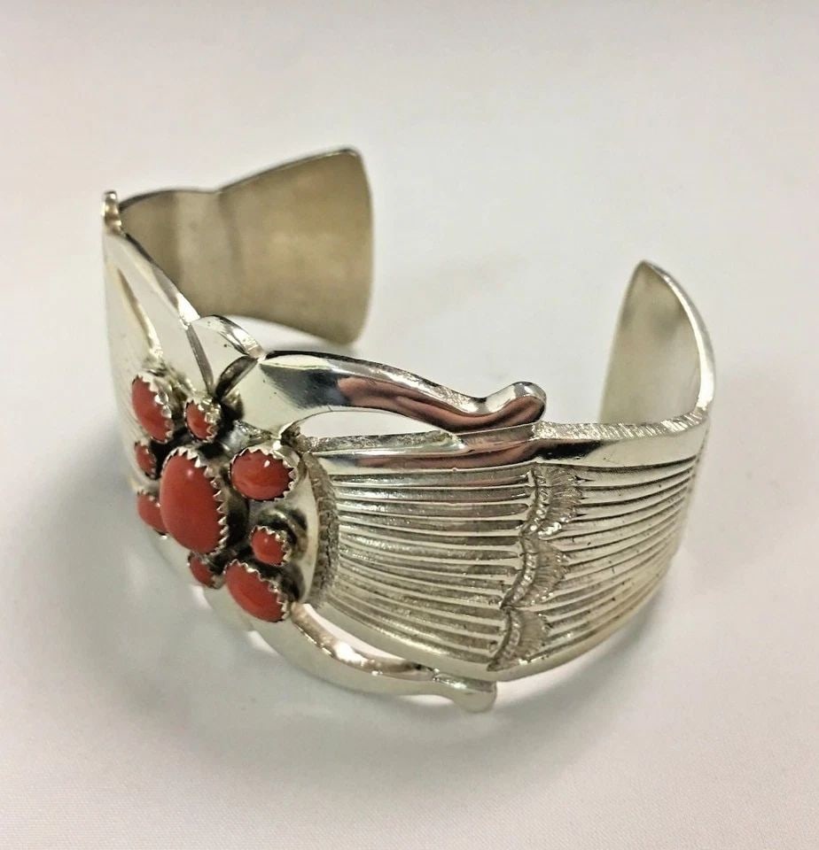 VINTAGE STERLING SILVER CUFF BRACELET, 9 NATURAL CORAL STONES 81.1 GRAMS: STERLING SILVER BRACELET CUFF WITH CORAL STONES Sterling Silver Cuff with Coral Stones You are bidding on a pre-owned Sterling Silver Cuff with Coral Stones. There are few minor scratches on the cuff 