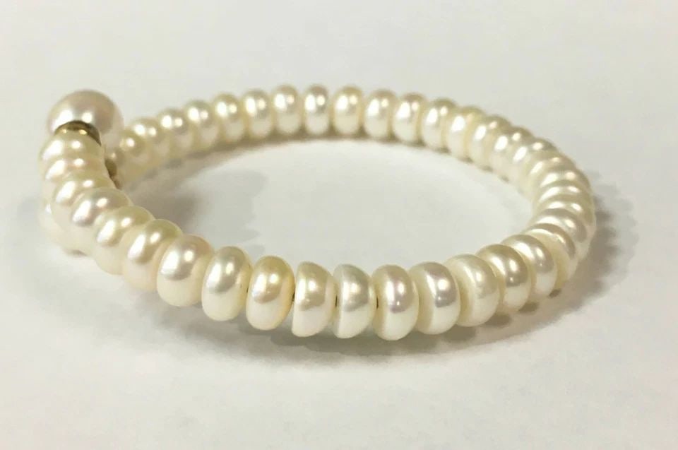 WHITE PEARL BANGLE WITH 14K YELLOW GOLD ACCENTS (6 INCH) 15.4 GRAMS: WHITE PEARL BANGLE WITH 14K ACCENTS (6 INCH WRIST) White Pearl Bangle with 14k Accents You are bidding on a White Pearl Bangle with 14k Accents. Bracelet is in good condition but one of the gold accen
