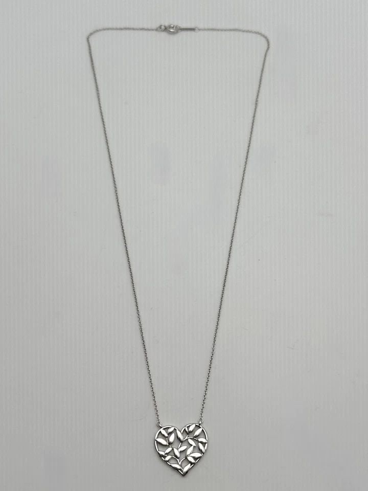 TIFFANY & CO. PALOMA PICASSO 925 SILVER OLIVE LEAF HEART PENDANT AND CHAIN 18": Tiffany & Co. Paloma Picasso Olive Leaf Heart Pendant and Chain Condition: Used Material: 925 Sterling Silver Necklace Size: 18 inches long, 0.5mm wide Pendant Size: 18mm x 16mm , measured at it's fur