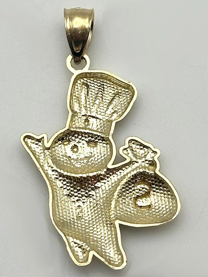 NEW 10K GOLD DOUGH BOY WITH MONEY BAG PENDANT 1.7 GRAMS: 10k Gold Dough Boy with Money Bag Pendant 1.7 grams Condition: Brand New, Display Model. Refer to condition description above and pictures. Material: 10k Yellow Gold Pendant Size: 20mm wide, 25mm tall