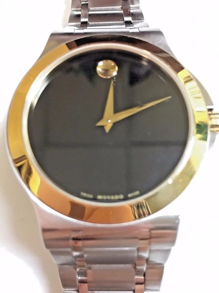 MOVADO SWISS MADE YELLOW GOLD TONE BEZEL 39MM CASE: MOVADO SWISS MADE YELLOW GOLD TONE BEZEL Mens Movado Watch You are looking at a pre owned Movado watch.The watch is in excellent working condition, has very minor scuffs and scratches on band and case