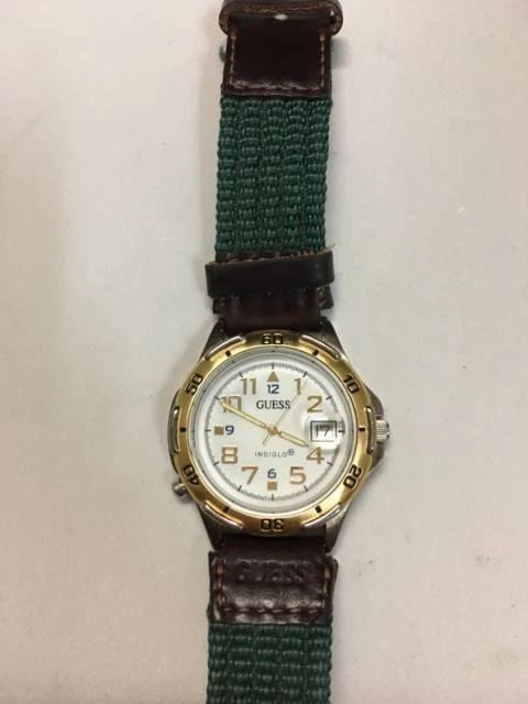 GUESS INDIGLO 1995 WITH YELLOW GOLD TONE BEZEL COLOR WATCH 36MM: GUESS INDIGLO 1995 WITH YELLOW GOLD TONE BEZEL COLOR WATCH Guess Indiglo 1995 with yellow gold tone bezel Watch You are bidding on a pre-owned Guess Indiglo 1995 with yellow gold tone bezel Watch. The