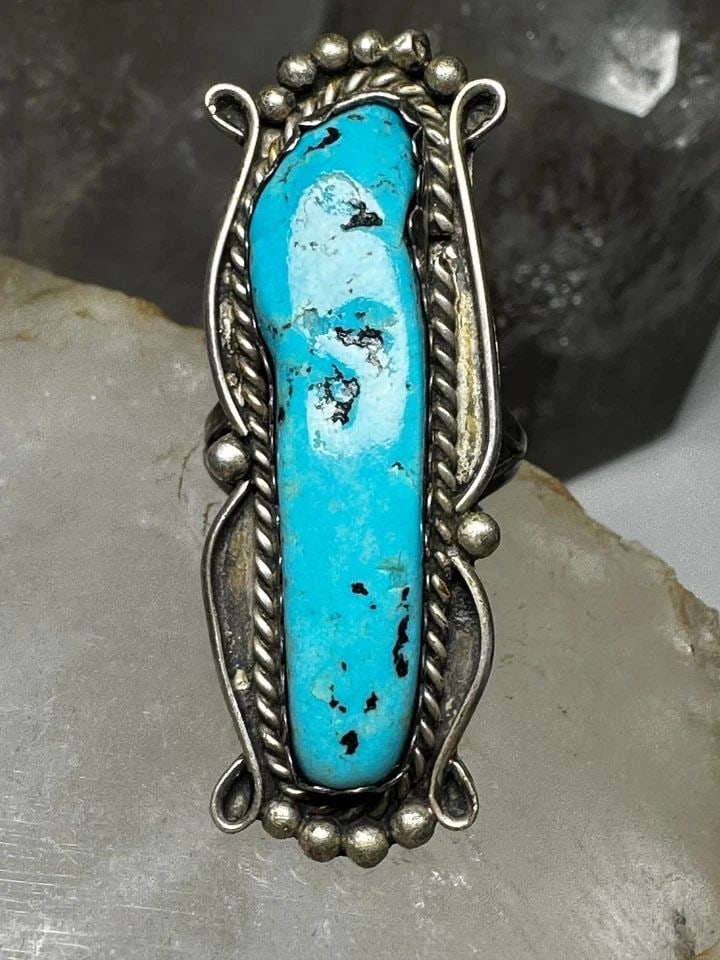 LONG TURQUOISE RING NAVAJO BAND SIZE 7.75 STERLING SILVER WOMEN: LONG TURQUOISE RING NAVAJO BAND SIZE 7.75 STERLING SILVER WOMEN Long Turquoise ring Navajo band size 7.75 sterling silver women Size 7.75 Between a size 7.75 and a size 8 Weight. 12.6g Length 2" Width
