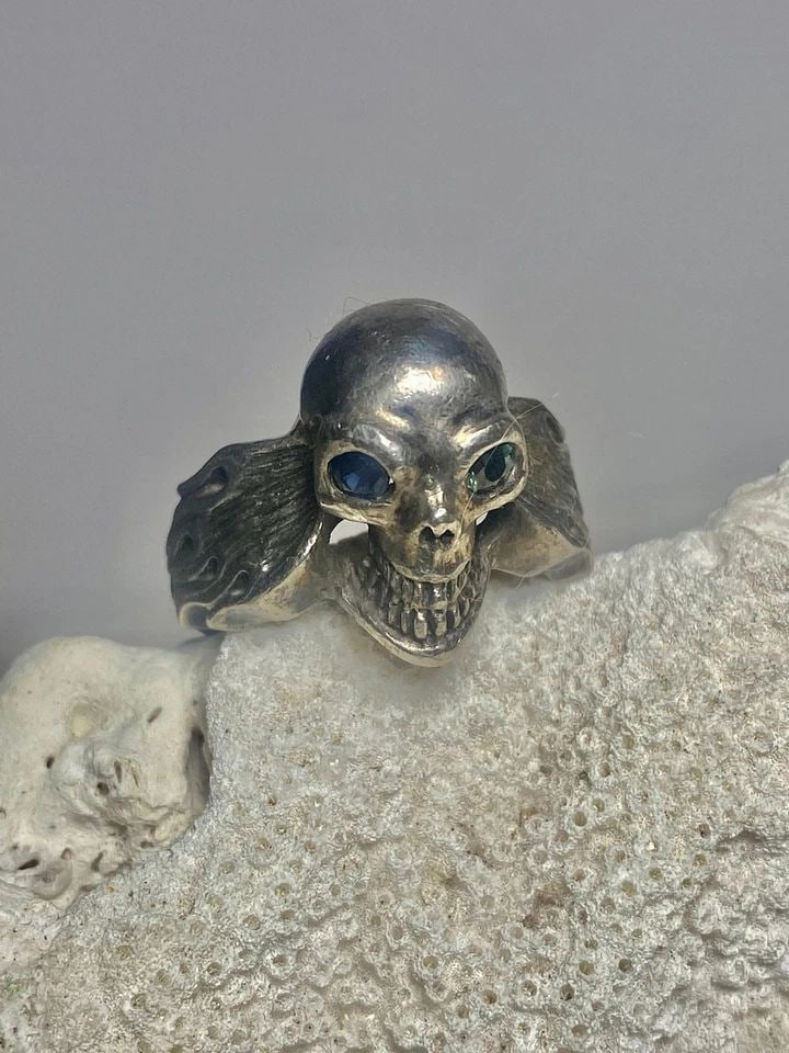 SKULL RING SIZE 8.75 BIKER FLAMES BAND STERLING SILVER WOMEN MEN: SKULL RING SIZE 8.75 BIKER FLAMES BAND STERLING SILVER WOMEN MEN Skull ring size 8.75 biker flames band w blue eyes sterling silver women men Size 8.75 Weight 11.9g Widest 3/4" Thinnest part 1/8"