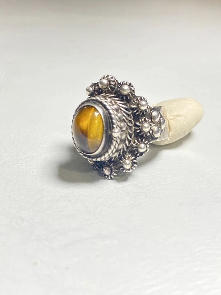 TIGER EYE POISON RING MEXICO STERLING SILVER WOMEN GIRLS: TIGER EYE POISON RING MEXICO STERLING SILVER WOMEN GIRLS Tiger Eye poison ring Mexico sterling silver women girls Size 7 adjustable Weight 10.7g Widest part of band 7/8" Thinnest part of band. 1/8" De