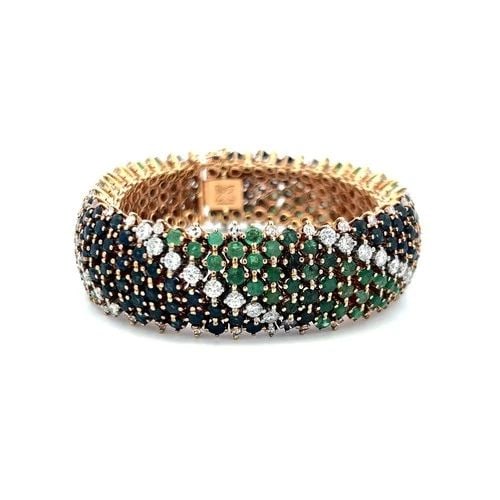SAPPHIRE, EMERALD & DIAMOND 18K YELLOW GOLD MULTI-ROW LINK BRACELET: SAPPHIRE, EMERALD & DIAMOND 18K YELLOW GOLD MULTI-ROW LINK BRACELET Title: This exceptional multi-row bracelet showcases a vibrant mosaic of natural sapphires, emeralds, and brilliant-cut diamonds met