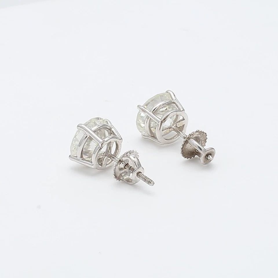 5.03 CARAT J–K I2 ROUND BRILLIANT DIAMOND 14K WHITE GOLD STUD EARRINGS: 5.03 CARAT J–K I2 ROUND BRILLIANT DIAMOND 14K WHITE GOLD STUD EARRINGS Title: These impressive 5.03 carat diamond stud earrings offer a bold, classic look with exceptional sparkle. Each earring feat