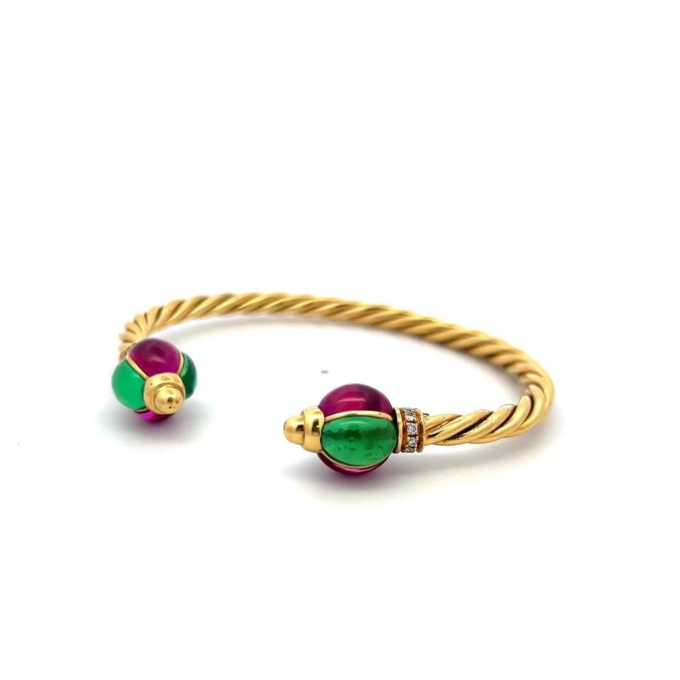 18K YG CUFF BRACELET WITH 0.12 CARAT DIAMONDS 9X6.6 MM GREEN SAPPHIRES & RUBIES: 18K YG CUFF BRACELET WITH 0.12 CARAT DIAMONDS 9X6.6 MM GREEN SAPPHIRES & RUBIES Detailed Description: Vintage Estate This vintage estate cuff showcases the opulence of 18K yellow gold, combining luxur