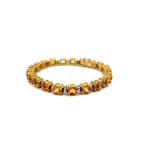 19.00 CARAT CITRINE & 0.70 CARAT DIAMOND 18K YELLOW GOLD TENNIS BRACELET: 19.00 CARAT CITRINE & 0.70 CARAT DIAMOND 18K YELLOW GOLD TENNIS BRACELET Title: This striking 18K yellow gold tennis bracelet showcases a vibrant arrangement of approximately 19.00 carats of richly sa