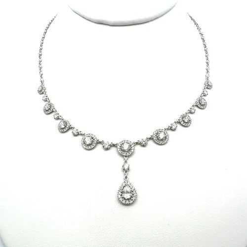 3.11 CARAT DIAMOND HALO DROP NECKLACE IN 18K WHITE GOLD WITH PEAR & ROUND ACCENT: 3.11 CARAT DIAMOND HALO DROP NECKLACE IN 18K WHITE GOLD WITH PEAR & ROUND ACCENT PRODUCT DESCRIPTION Title: This elegant 18K white gold necklace showcases 3.11 carats of mixed-cut natural diamonds arr