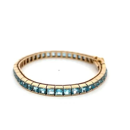 VINTAGE 14K YELLOW GOLD TENNIS BRACELET WITH 4.06X3.31 MM BLUE TOPAZ: VINTAGE 14K YELLOW GOLD TENNIS BRACELET WITH 4.06X3.31 MM BLUE TOPAZ VINTAGE 14K YELLOW GOLD TENNIS BRACELET WITH 4.06X3.31 MM BLUE TOPAZ PRODUCT DESCRIPTION Detailed Description: 20.4 Grams Bask in t