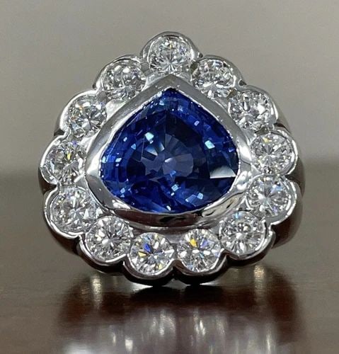 6.02CT PEAR SHAPE BLUE SAPPHIRE AND DIAMOND RING IN 18KT WHITE GOLD: 6.02CT PEAR SHAPE BLUE SAPPHIRE AND DIAMOND RING IN 18KT WHITE GOLD Blue Sapphire and Diamond Ring 6.02ct Pear Shape Blue Sapphire 2.08ct Sparkling Diamonds 750, 18K White Gold Size 7.5 (adjustable) B