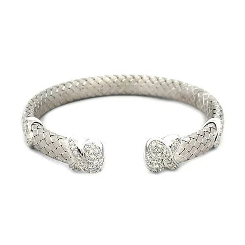 DIAMOND GOLD CUFF BRACELET 18K WHITE PAVE SET BASKET WEAVE STYLE ARIMAR: DIAMOND GOLD CUFF BRACELET 18K WHITE PAVE SET BASKET WEAVE STYLE ARIMAR The Diamond Gold Cuff Bracelet signed Arimar is a stunning piece of fine jewelry crafted from 18k white gold. The bracelet featu