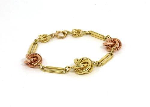 RETRO GOLD LOVE KNOT BRACELET 14K ROSE YELLOW FLORAL STYLE 1940'S: RETRO GOLD LOVE KNOT BRACELET 14K ROSE YELLOW FLORAL STYLE 1940'S The Retro Gold Love Knot Bracelet is a vintage piece from the 1940s, showcasing 3 charming knot shape in pink and yellow gold with ope