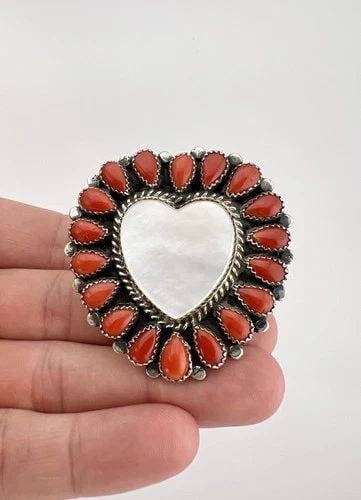 EDNEI YABENY NAVAJO STERLING SILVER CORAL & MOTHER OF PEARL CLUSTER HEART RING: Ednei Yabeny Navajo Sterling Silver Coral & Mother of Pearl Cluster Heart Ring Ring Size: 9.5 - Adjustable In Size Weight is 34.0 Grams on my scale Metal: Sterling Silver Face of The Ring is 2" Tall I